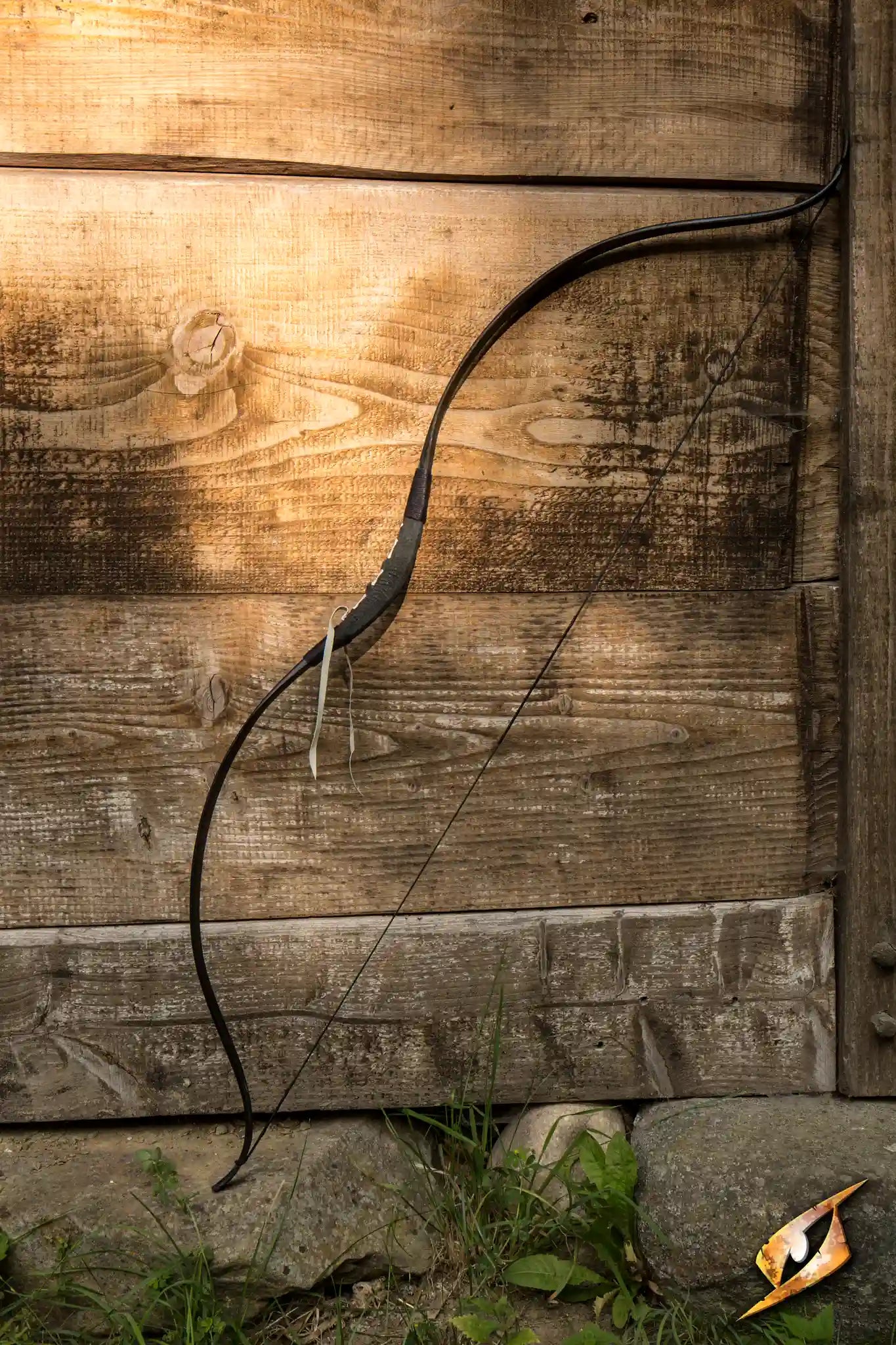 RFB Bow - M displayed against a rustic wooden background, showcasing its sleek design and craftsmanship.