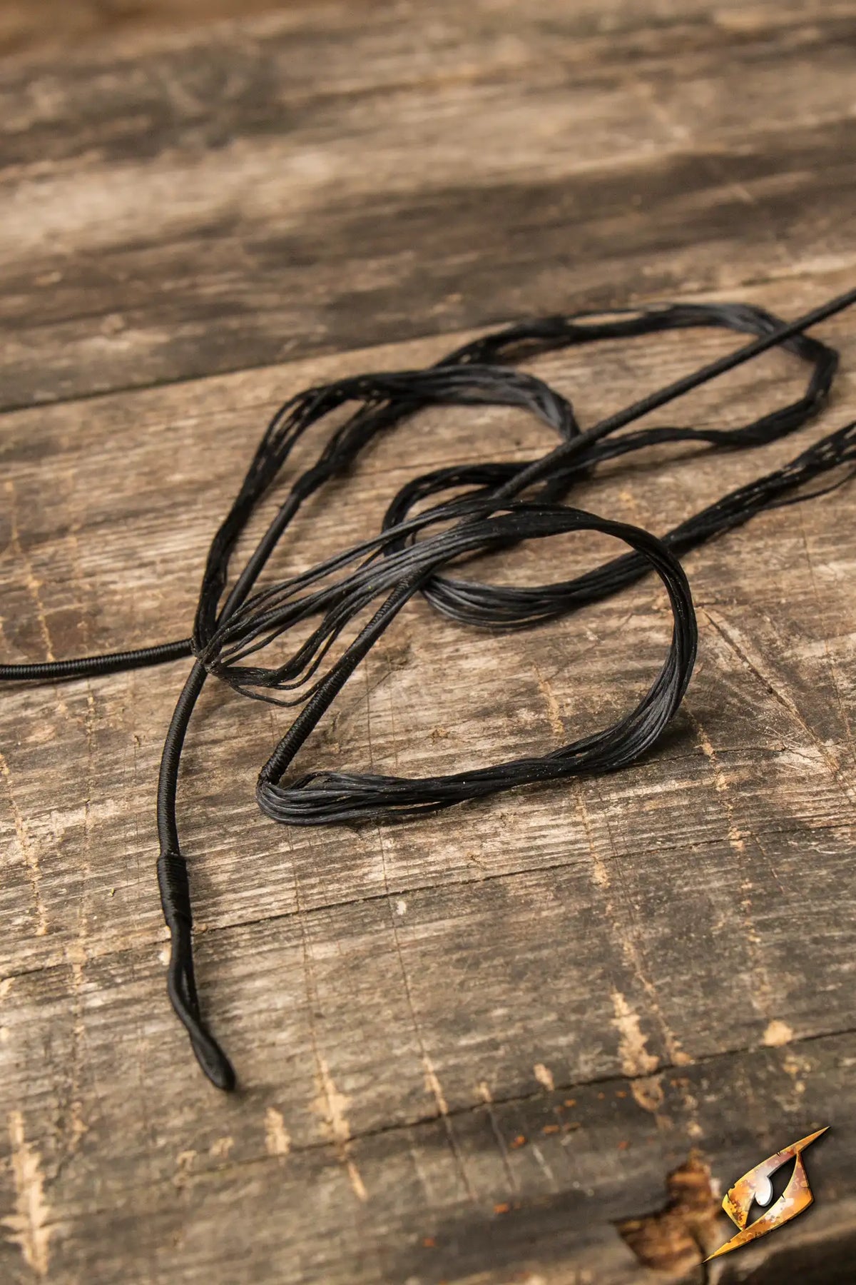 Bow String on a wooden surface, showcasing Epic Armoury's 152 cm replacement Bow String for Flatbow.
