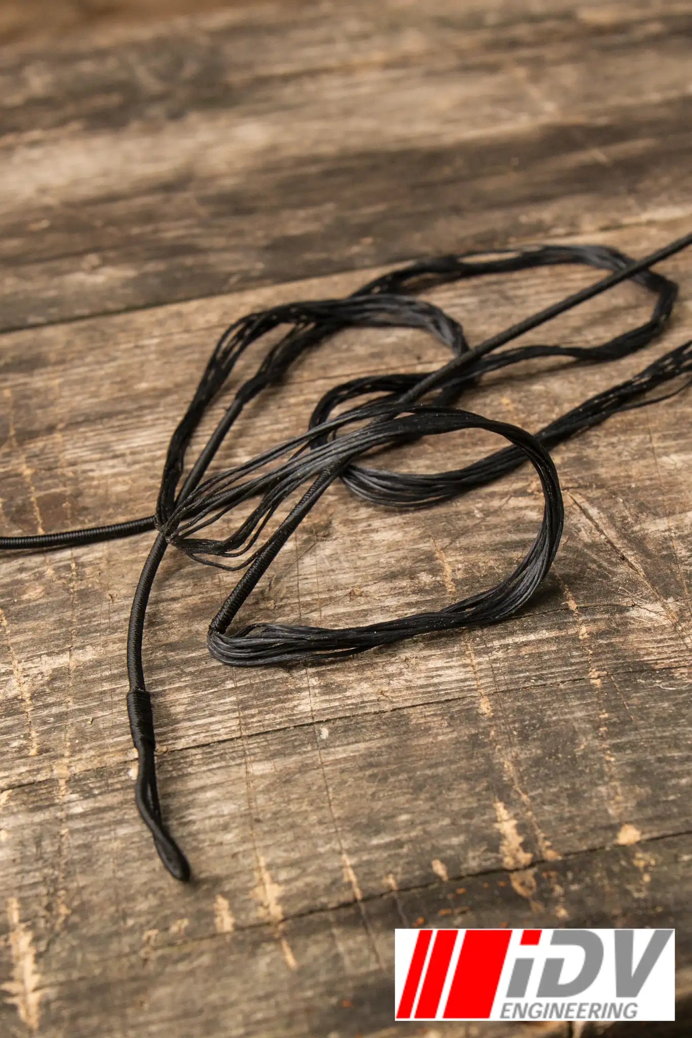 Close-up of Bow String IDV crafted by iDV Engineering on wooden surface.