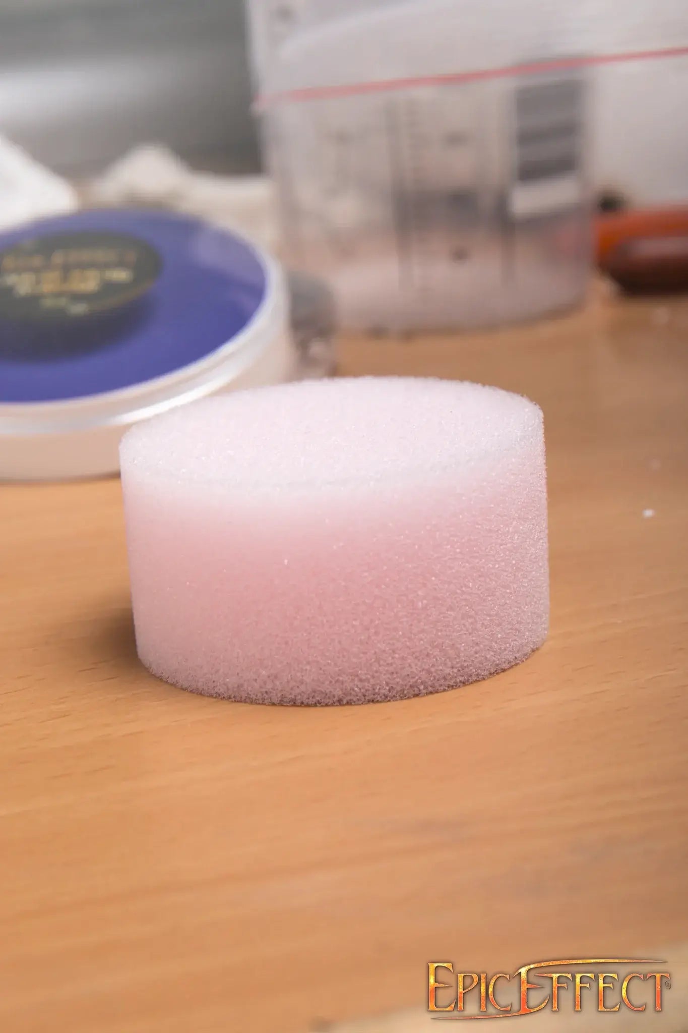 Round Makeup Sponge on a wooden surface, perfect for applying water-based and cream-based cosmetics.