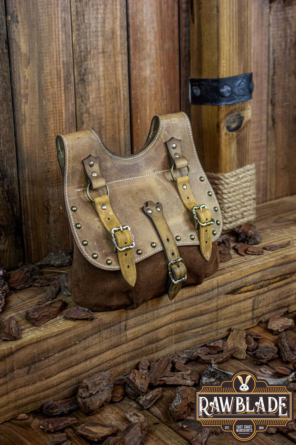 Agor Belt Bag in brown leather with unique straps and studs, perfect for accessorizing any outfit.