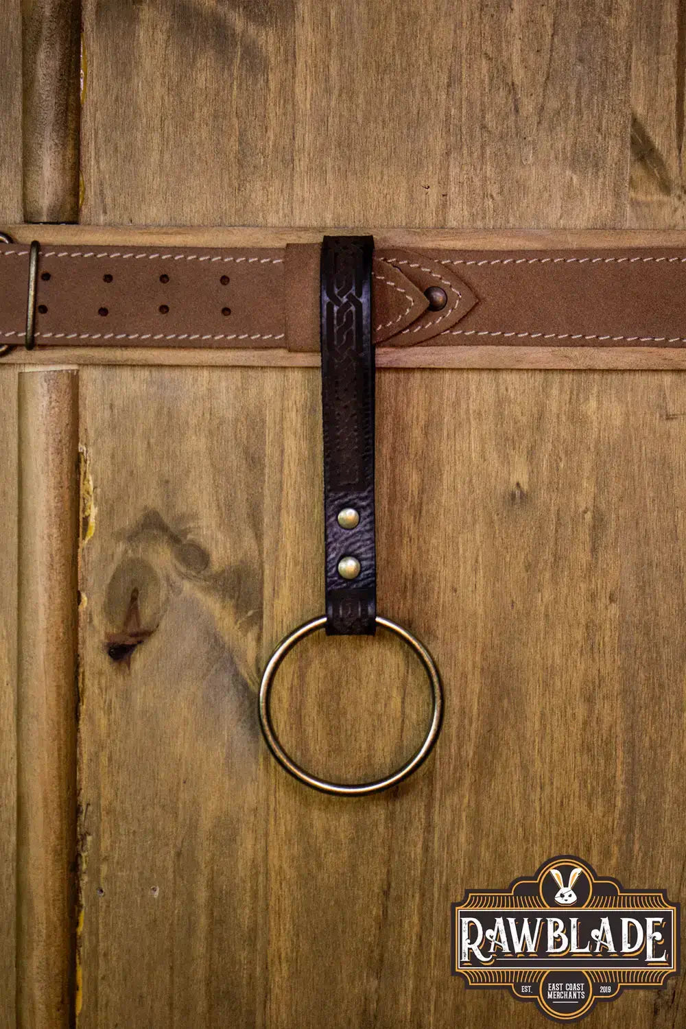 Runar Ring Holder attached to a leather belt, featuring a decorative leather strap and gold rivets.