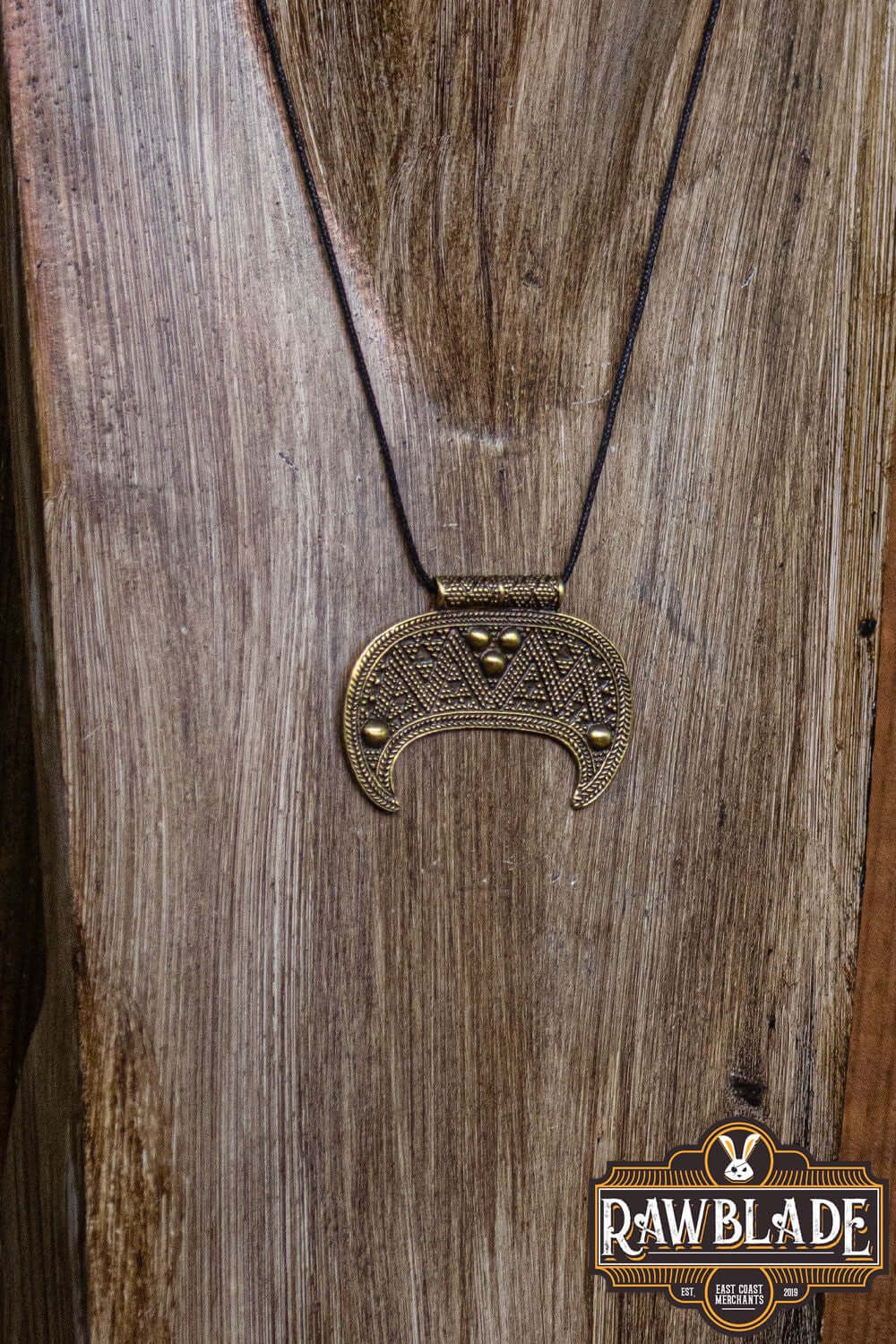 Lunula Chieftain Pendant showcasing intricate design on a sturdy cord, perfect for minimalist jewelry enthusiasts.